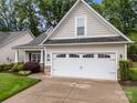 A two-car garage with decorative windows sits at the front of this meticulously kept home at 422 Drake Ln, Salisbury, NC 28146