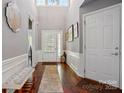 Inviting foyer featuring gleaming hardwood floors, a high ceiling, and stylish decor at 43041 Mimosa Ct, Fort Mill, SC 29707