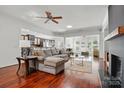 Spacious living room featuring hardwood floors, a ceiling fan, and an open floor plan at 43041 Mimosa Ct, Fort Mill, SC 29707