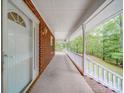 Inviting front porch with a white railing, offering a serene outdoor space with views of the surrounding landscape at 4620 Binwhe Ln, Gastonia, NC 28052