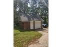 Detached two-car brick garage with white doors, offering additional parking and storage space at 4620 Binwhe Ln, Gastonia, NC 28052