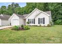 Beautiful, well maintained lawn surrounding home with manicured landscaping and flowerbeds at 4719 Sahalee Ln, Charlotte, NC 28216
