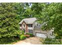Beautiful two-story home with brick facade and attached garage, surrounded by lush greenery and mature trees at 4846 Deer Cross Trl, Charlotte, NC 28269