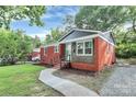 Quaint brick home with a well-manicured lawn and inviting walkway, offering a blend of classic charm and modern updates at 4913 Winchester St, Charlotte, NC 28208