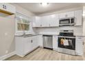 Modern kitchen with white cabinets, stainless steel appliances, and granite countertops at 5715 Coulee Pl, Charlotte, NC 28217