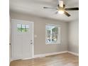 Cozy room with a ceiling fan, a white door with glass panes, and natural light at 5715 Coulee Pl, Charlotte, NC 28217