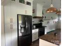 Modern kitchen with stainless steel appliances, white cabinetry, and butcher block countertop at 6650 Highway 341 Hwy, Kershaw, SC 29067