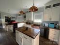 Bright kitchen with a central island, pendant lighting, a copper sink, and stainless steel appliances at 6650 Highway 341 Hwy, Kershaw, SC 29067