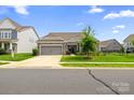 Beautiful home with a well-kept lawn, stone accents, and a two-car garage in a residential neighborhood at 7016 Bareland Rd, Fort Mill, SC 29707