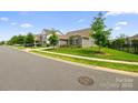 View of the home from the street, showcasing its landscaped front yard and neighborhood setting at 7016 Bareland Rd, Fort Mill, SC 29707