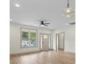 Open living area shows hardwood floors, neutral paint and trim, and lots of natural light at 705 Sunderland Sw Rd, Concord, NC 28027