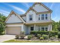 Beautiful two-story home with a tidy front yard and a spacious two-car garage at 7166 Dove Field Ln, Fort Mill, SC 29707