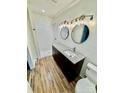 Bathroom features a modern vanity with granite top, dual mirrors, and walk-in tiled shower at 820 Kerley Ct, Statesville, NC 28677