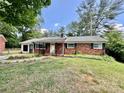 Traditional brick ranch with manicured lawn, mature trees, and updated windows at 820 Kerley Ct, Statesville, NC 28677