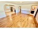 Open concept living area with hardwood floors, connecting living room, kitchen and bathroom at 820 Kerley Ct, Statesville, NC 28677