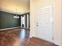 Dining room with dark grey walls, hardwood floors, and chandelier at 9027 Gray Willow Rd, Charlotte, NC 28227