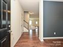 Foyer with hardwood floors, stairs and a view into the living area at 9027 Gray Willow Rd, Charlotte, NC 28227