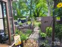 Enchanting backyard oasis with lush greenery, a garden, and a charming patio area at 903 W Oak St, Shelby, NC 28150