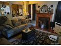 Cozy living room with a classic fireplace, comfortable seating, and stylish decor at 903 W Oak St, Shelby, NC 28150