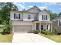Charming two-story home features a well-manicured lawn and an attached two-car garage at 941 Rachel Anne Dr, Belmont, NC 28012