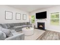 Comfortable living room with fireplace, large gray sectional sofa, neutral paint, and lots of natural light at 941 Rachel Anne Dr, Belmont, NC 28012