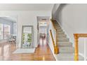 Inviting foyer with hardwood floors, a staircase, and views into the dining and living areas at 9775 Mallard Glen Dr, Charlotte, NC 28262