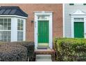 Close-up of the front door with brick facade and manicured shrubs at 9775 Mallard Glen Dr, Charlotte, NC 28262