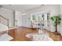 Open-concept living area with hardwood floors, a bay window, and ample natural light at 9775 Mallard Glen Dr, Charlotte, NC 28262