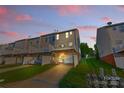 Townhome rear view showing decks, garages, and well-maintained lawn at 9775 Mallard Glen Dr, Charlotte, NC 28262