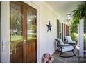 Inviting front porch with rocking chairs and decorative door with sidelights at 1014 Covewood Ct, Charlotte, NC 28270