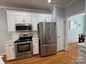 Modern kitchen featuring stainless steel appliances, white cabinets, and subway tile backsplash at 1043 Cambrook Ct, Concord, NC 28027