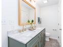 Elegant bathroom featuring a marble countertop with double sinks and stylish green cabinetry at 10743 Ola Dr, Fort Mill, SC 29707