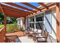 Cozy covered porch features a seating area with outdoor furniture and a decorative wood pergola at 10743 Ola Dr, Indian Land, SC 29707