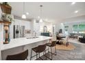 Modern kitchen featuring a quartz countertop island with barstool seating and stainless steel appliances at 117 Lanyard Dr # E, Mooresville, NC 28117