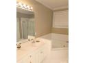 Bright bathroom showcases a garden tub, glass shower and vanity with a white countertop at 1253 Iverleigh Trl, Charlotte, NC 28270