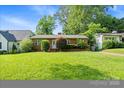 Quaint brick house featuring a lush green lawn and a well-kept garden at 1315 Cortland E Rd, Charlotte, NC 28209