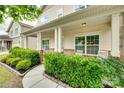 Charming front porch featuring decorative brick accents and neatly trimmed landscaping at 1412 Afternoon Sun Rd, Matthews, NC 28104