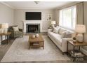 Inviting living room featuring comfortable seating, a fireplace, and ample natural light, creating a warm and inviting space at 1421 Thompson Ave, Charlotte, NC 28216