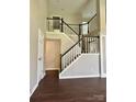 Spacious foyer with a beautiful staircase and dark wood floors at 14211 Harlequin Dr, Charlotte, NC 28273