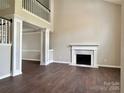 Bright living room with a fireplace and beautiful hardwood floors at 14211 Harlequin Dr, Charlotte, NC 28273