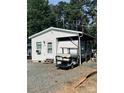One-story home with an RV parked under a covered area, providing convenient outdoor living space at 146 Larboard Trl, Mount Gilead, NC 27306