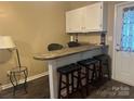 A charming kitchenette features stylish seating, complemented by ample cabinet space and modern finishes at 146 Larboard Trl, Mount Gilead, NC 27306