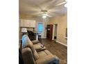 Inviting living room featuring a cozy couch, a kitchenette, and wood-look floors at 146 Larboard Trl, Mount Gilead, NC 27306