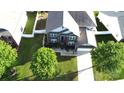 Aerial shot showcasing a well-maintained two-story home with lush greenery and a white picket fence at 14615 Bridle Trace Ln, Pineville, NC 28134