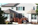 The rear exterior features a wooden deck with grill, offering an outdoor space for relaxation and entertainment at 14615 Bridle Trace Ln, Pineville, NC 28134