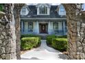 Close up of beautiful home's front exterior with a stone archway, porch, and landscaped front yard at 150 8Th Ave, New London, NC 28127
