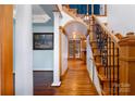 Foyer with wooden staircase, hardwood floors, and decorative archway leading to other rooms at 150 8Th Ave, New London, NC 28127