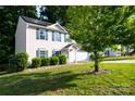 Charming two-story home with a two car garage, solar panels, and a well-manicured front lawn at 1518 Glenbar Ct, Clover, SC 29710