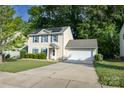 Charming two-story home with a two car garage, solar panels, and a well-manicured front lawn at 1518 Glenbar Ct, Clover, SC 29710