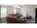 Living room featuring a large sectional sofa, ceiling fan, and view of the outdoors at 1518 Glenbar Ct, Clover, SC 29710